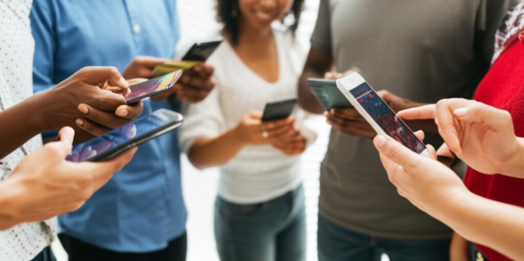 People in developing countries using smartphones for financial services, showcasing Fintech's impact.